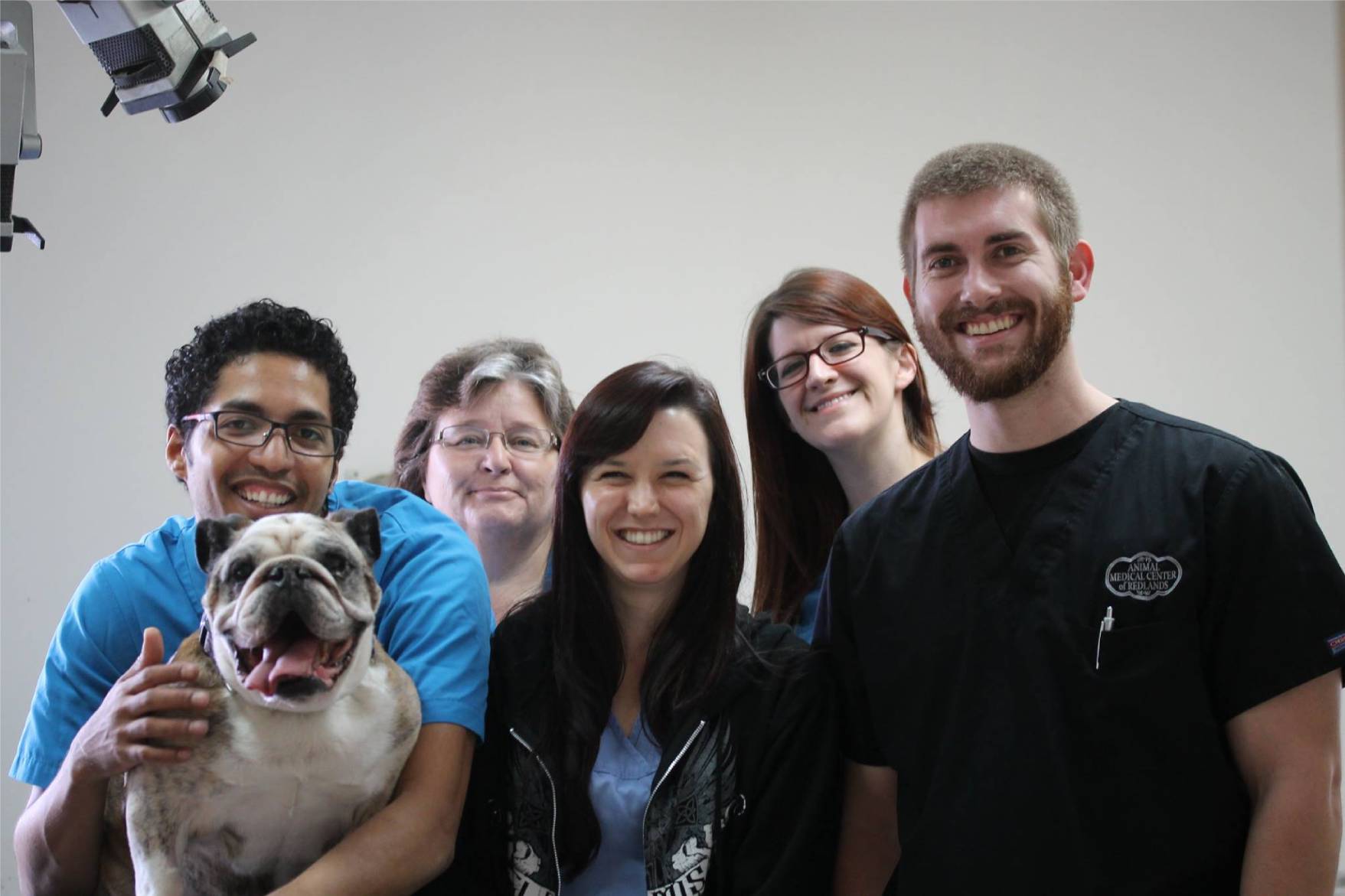 a group of people posing for a photo with a dog